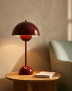 Red cordless lamp on side table