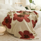 Red floral fleece throw on bed