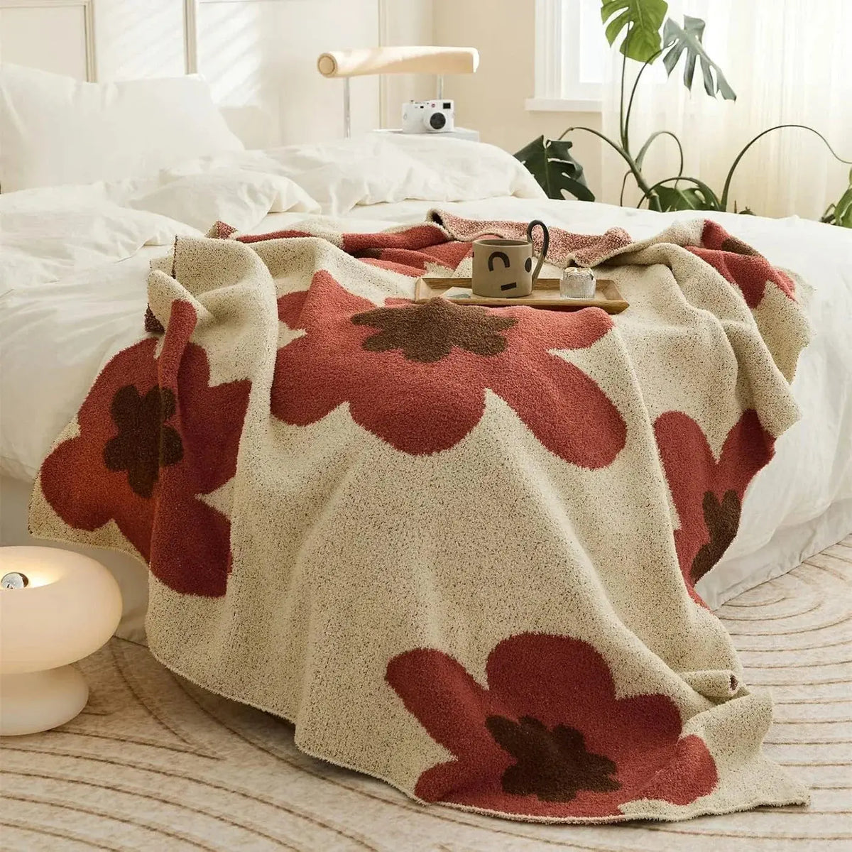 Red floral fleece throw on bed