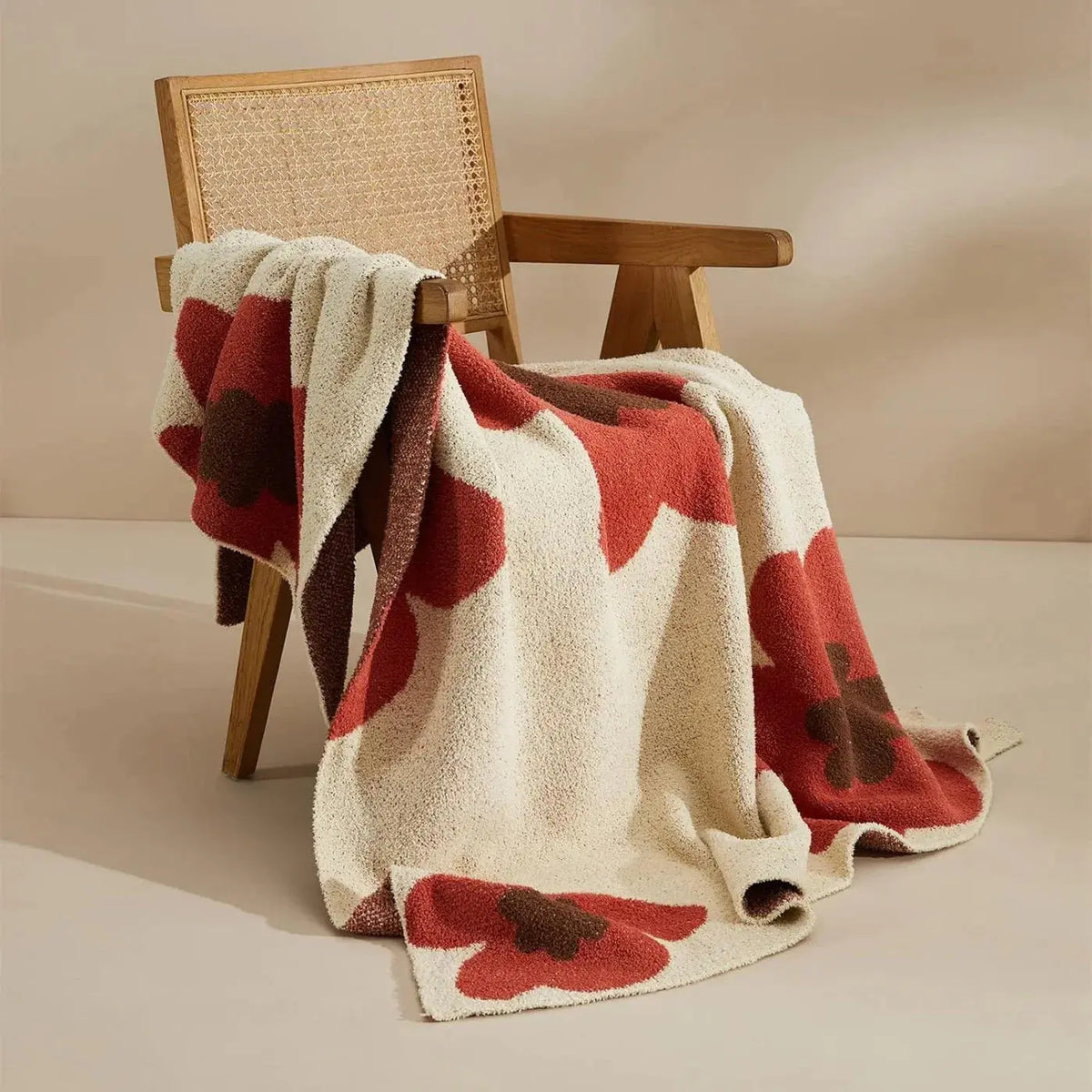 Red floral throw blanket on chair