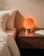 Red globe lamp on nightstand