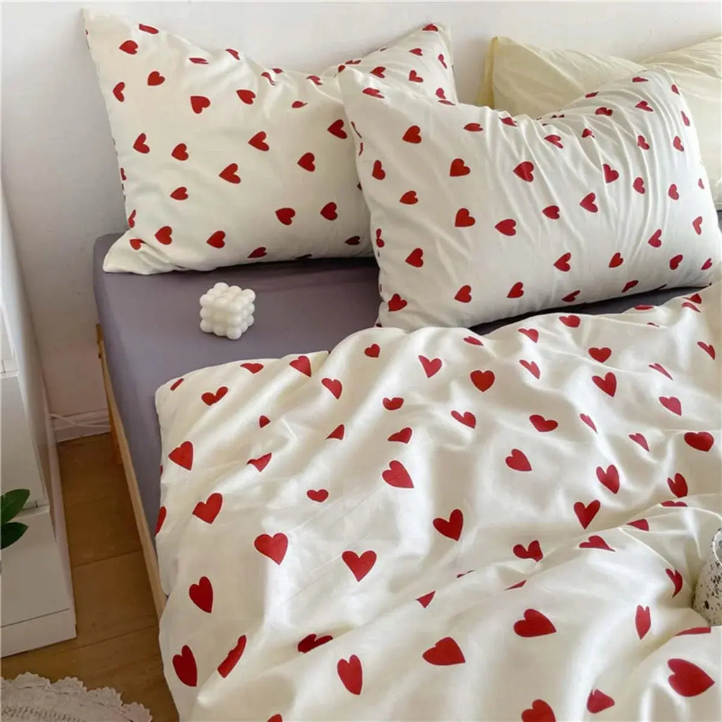Red heart print bedding set on bed