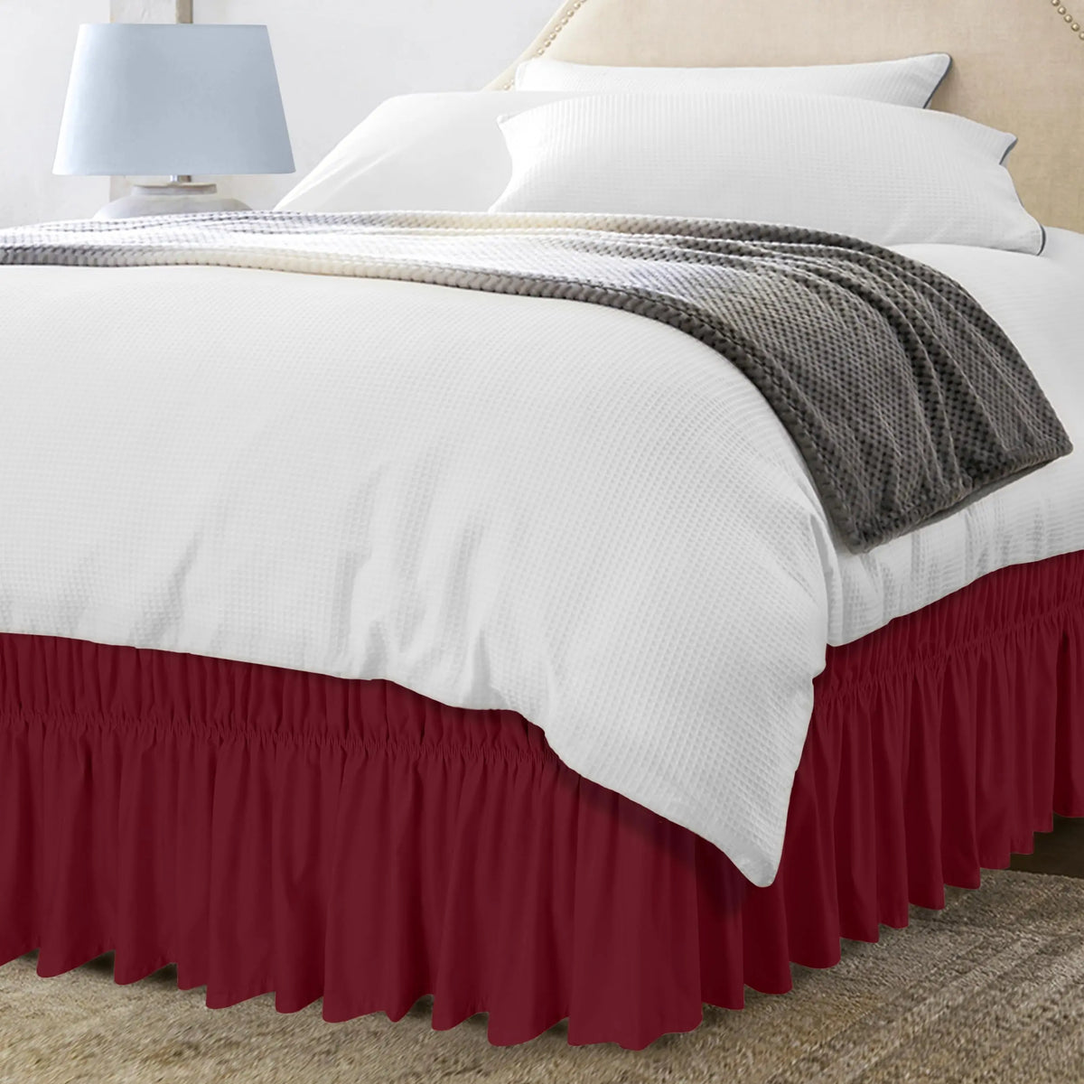 Red ruffled bed skirt on bed