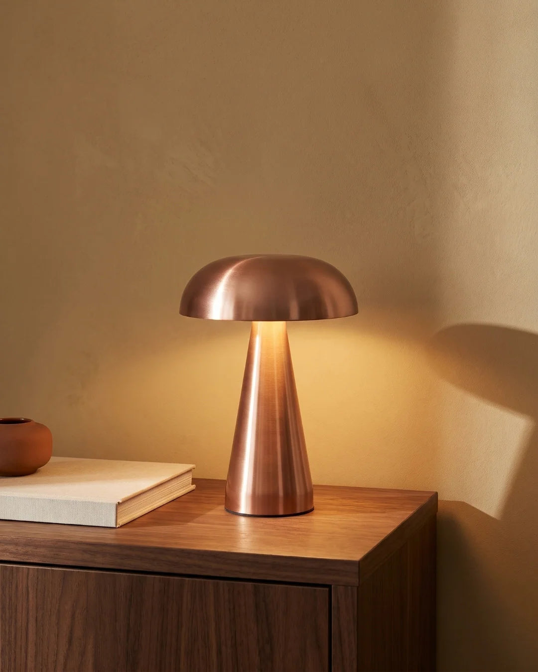 Rose gold lamp on nightstand