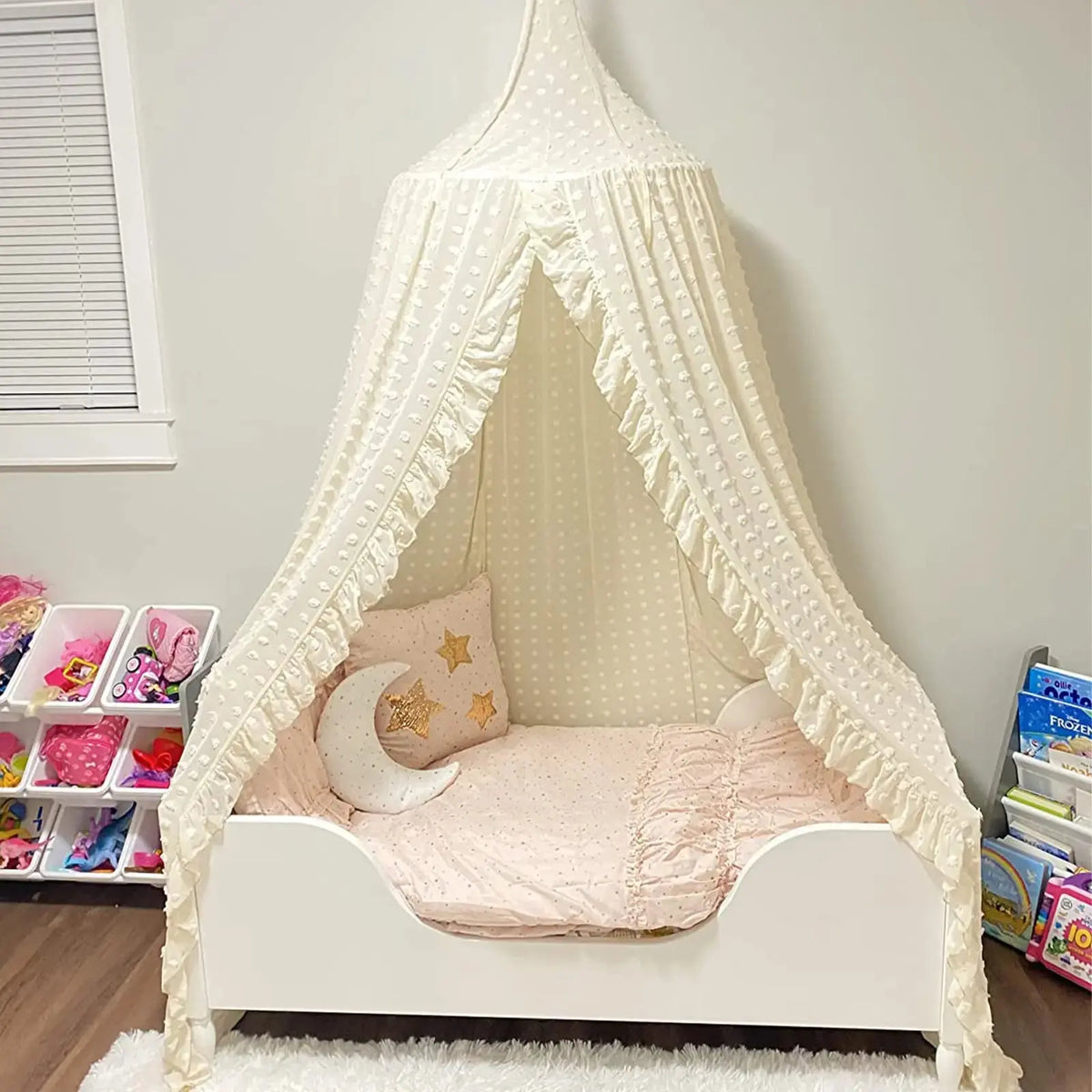 Ruffled cream canopy over kids bed