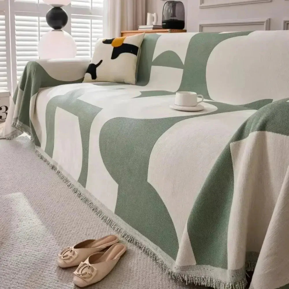 Sage green geometric couch cover on sofa