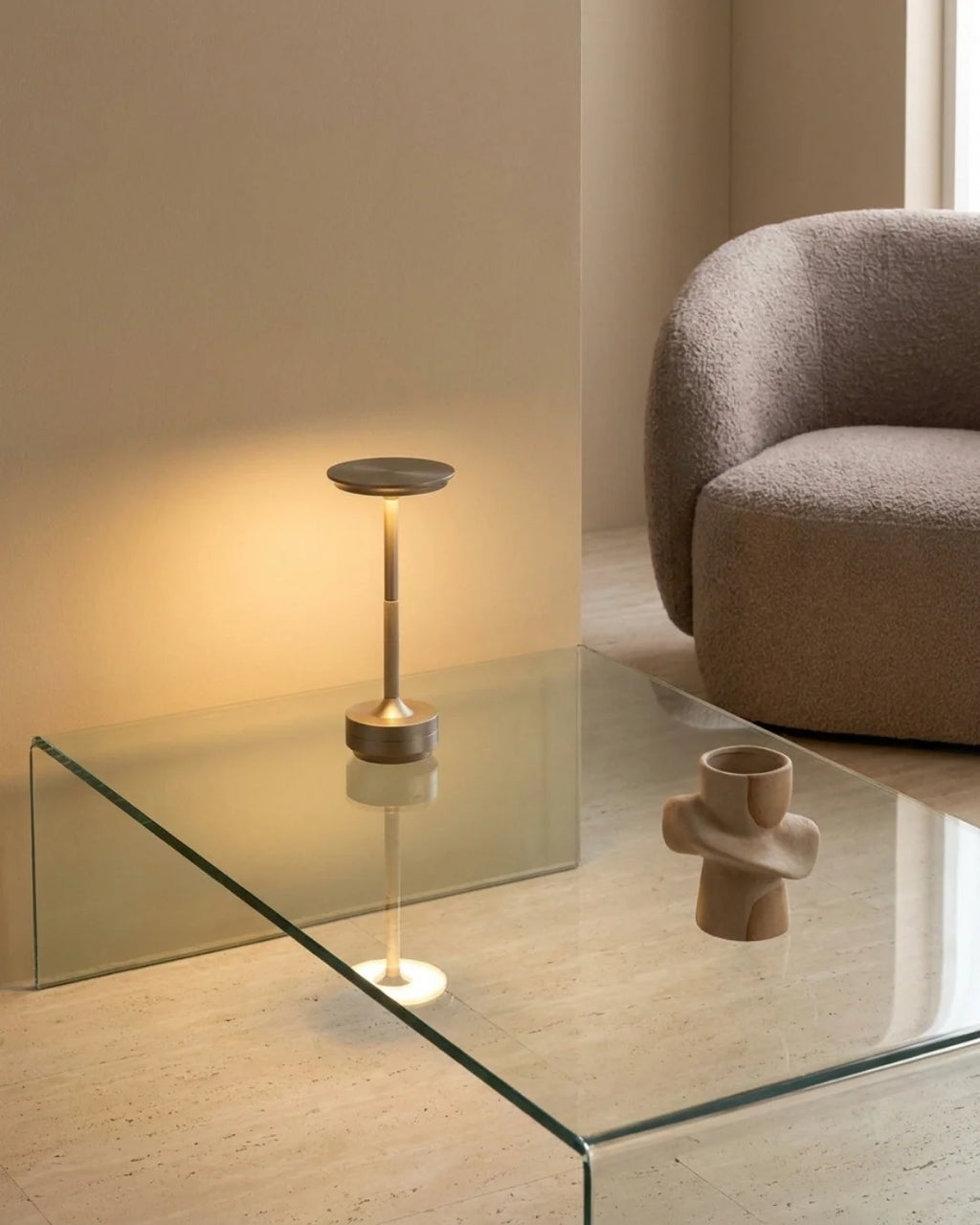 Silver cordless lamp on glass coffee table