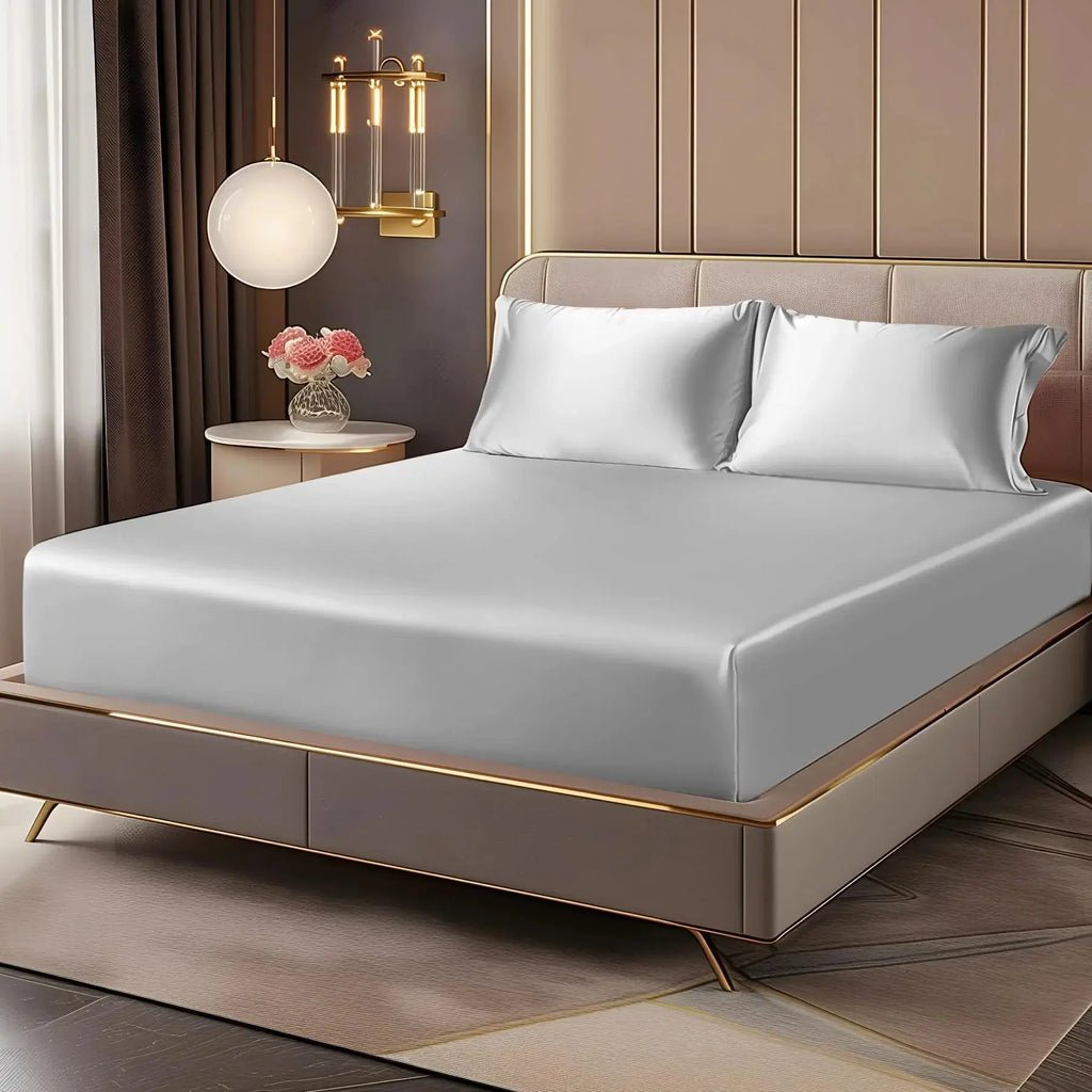 Silver satin sheet set on bed
