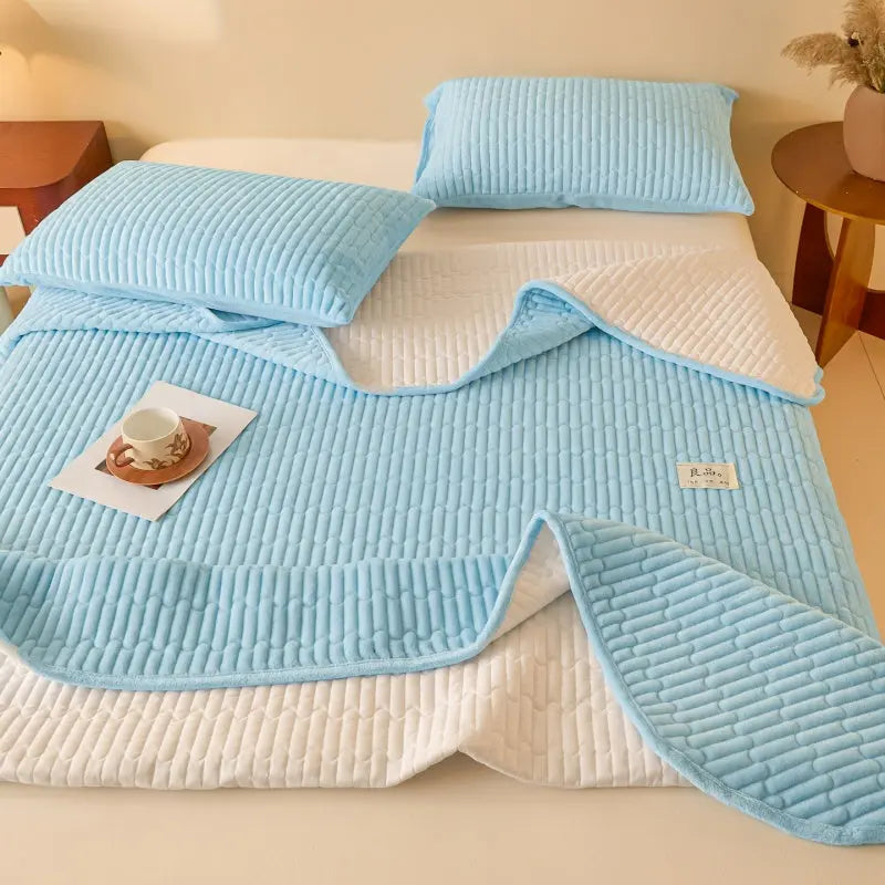 Sky blue coverlet folded back on bed