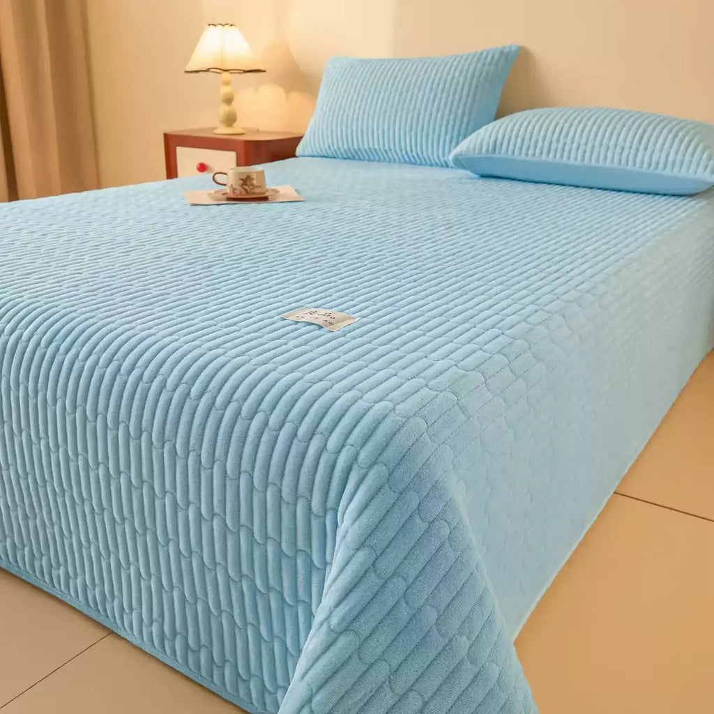 Sky blue quilted coverlet set on bed
