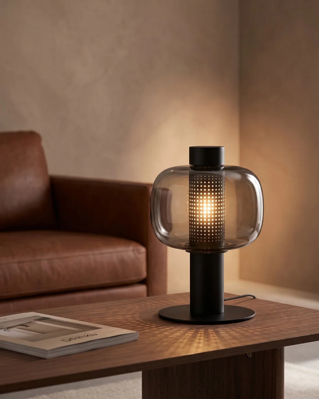Smoked glass lamp by leather sofa