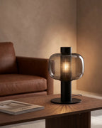 Smoked glass lamp by leather sofa