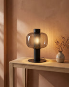 Smoked glass lamp on console table