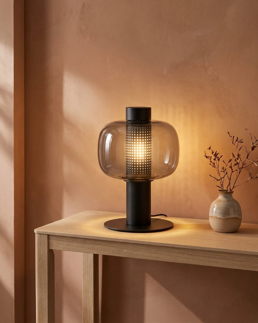 Smoked glass lamp on console table