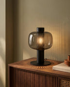Smoked glass lamp on sideboard