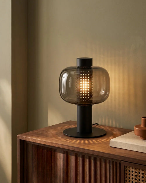 Smoked glass lamp on sideboard
