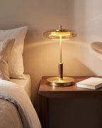 Smoked glass table lamp on nightstand