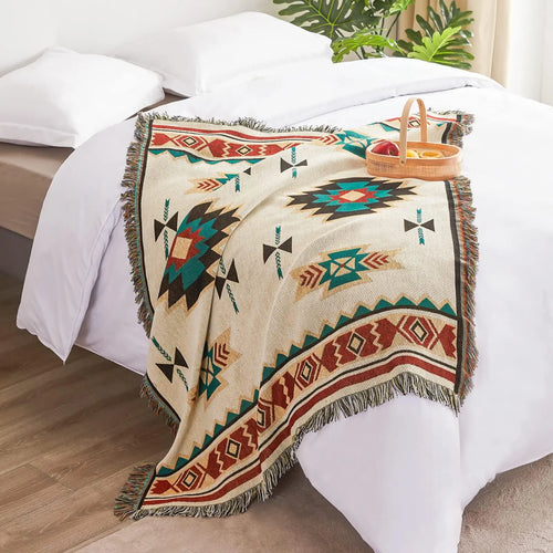 Southwestern throw blanket with fringe on bed