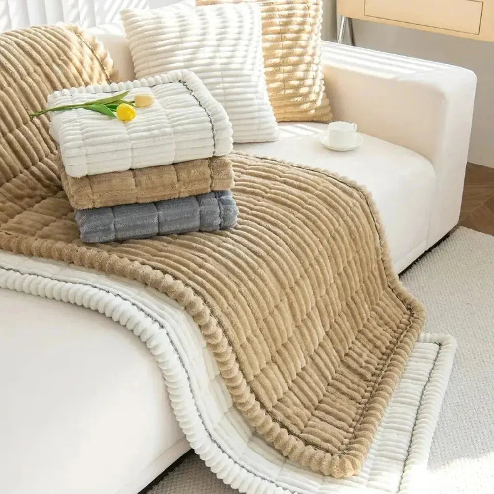 Stack of plush couch cushion covers in beige, gray and green