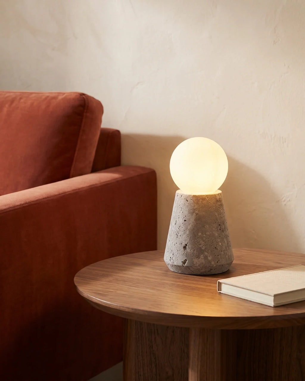 Travertine lamp on side table by sofa