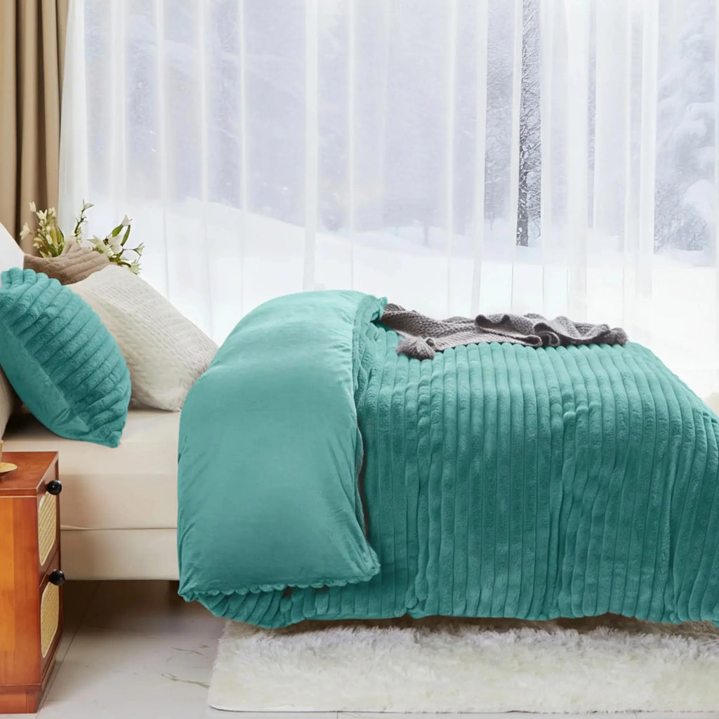 Turquoise plush duvet cover on bed by window