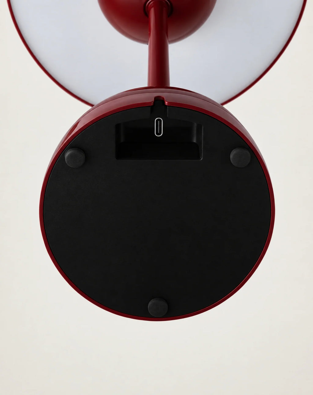 Underside of red cordless lamp