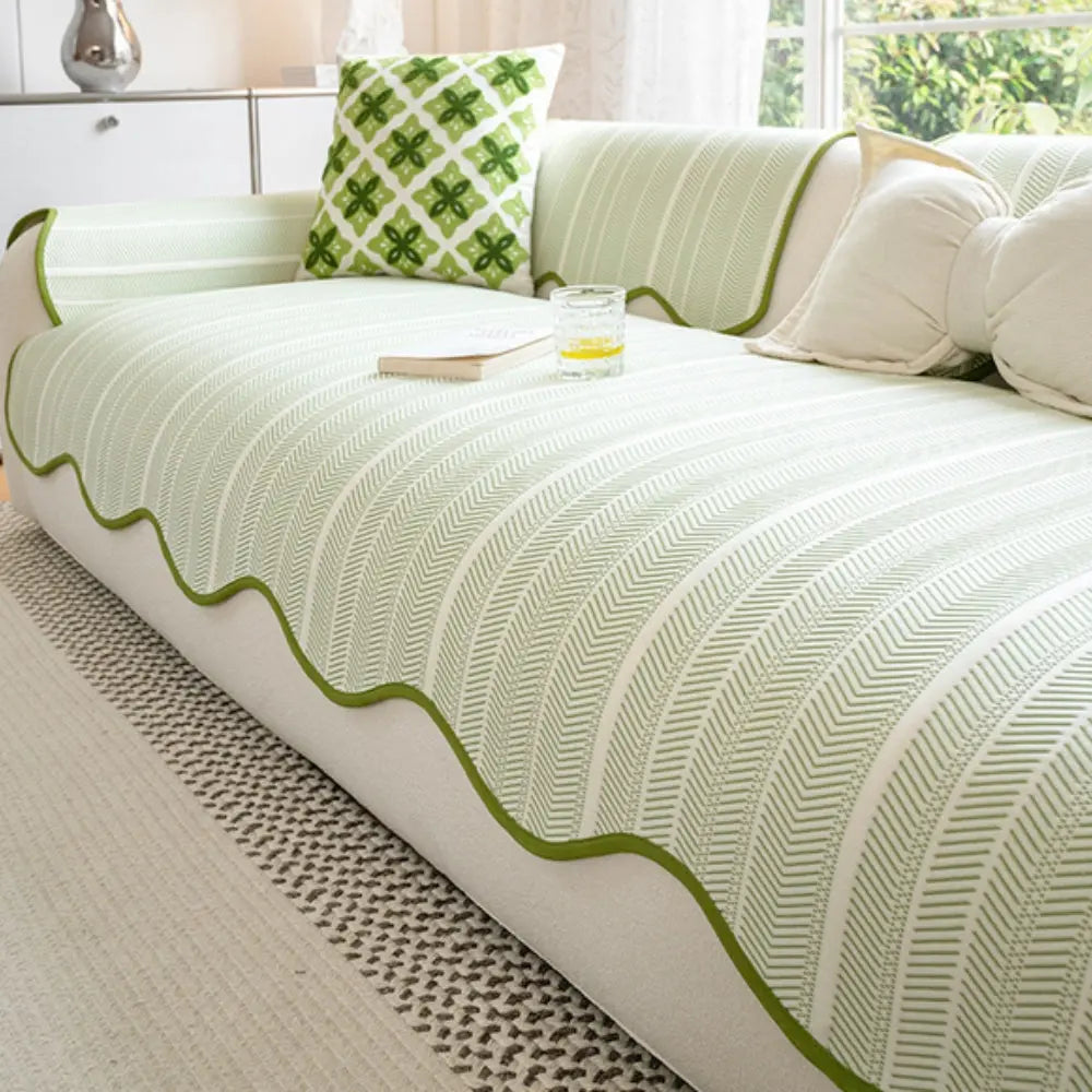 Washable couch cover with sage green scalloped edge on sofa