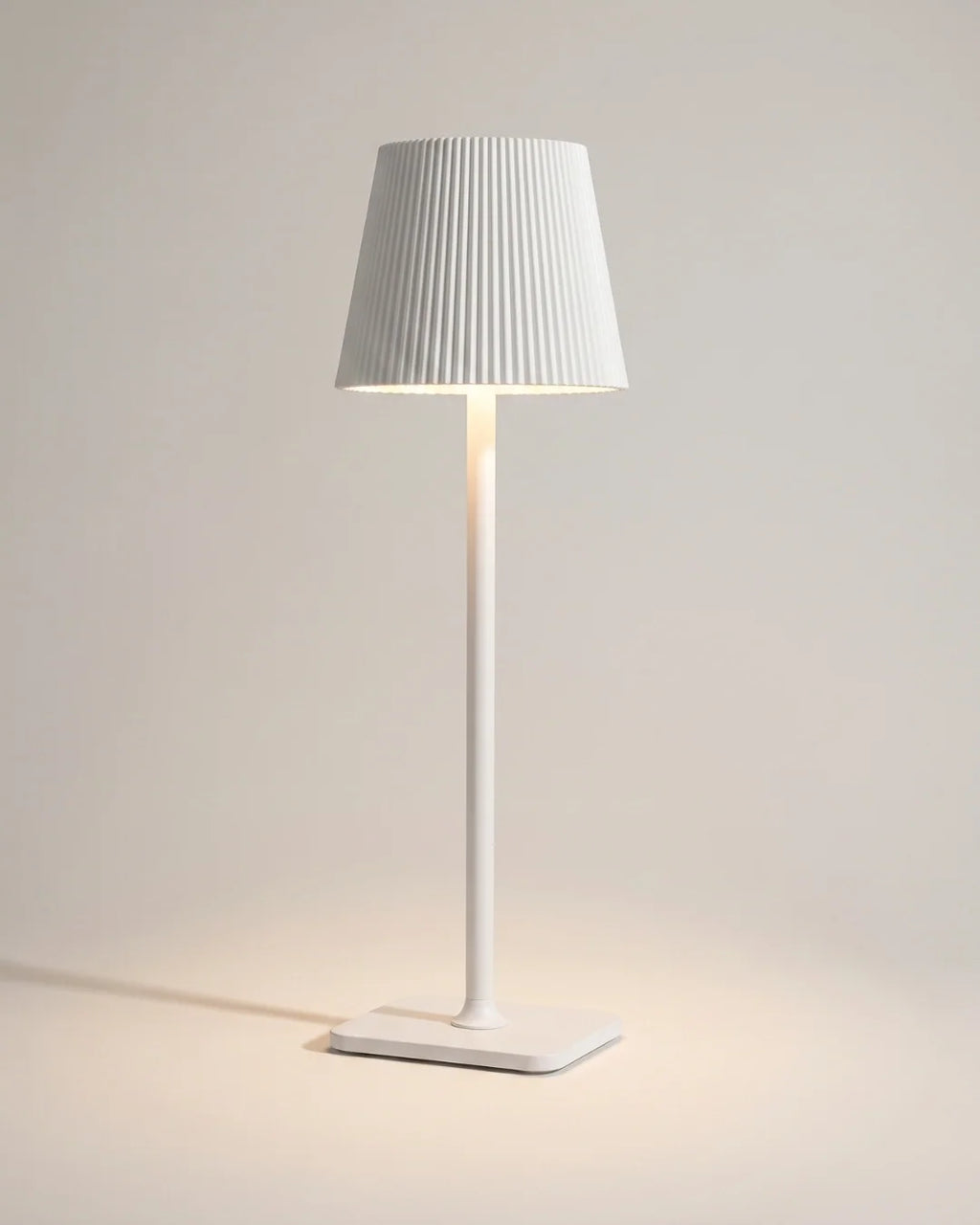White cordless table lamp with pleated shade