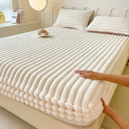 White faux fur fitted sheet on bed