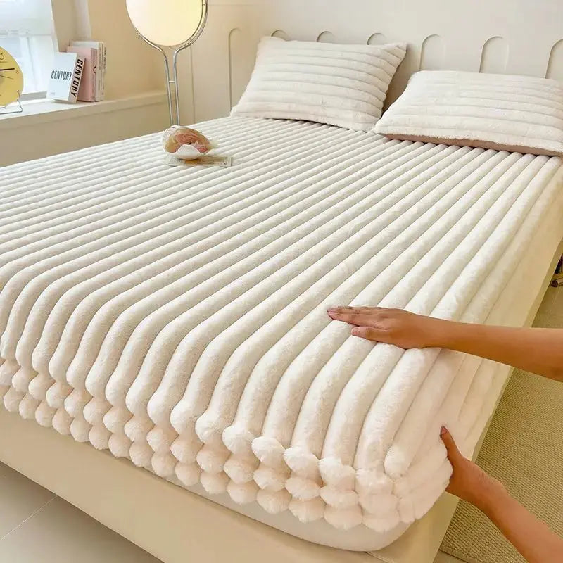 White faux fur fitted sheet on bed