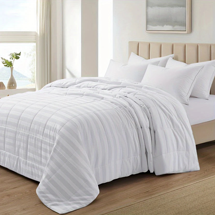 White lightweight summer comforter on bed