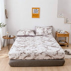 White marble print fitted sheet on bed
