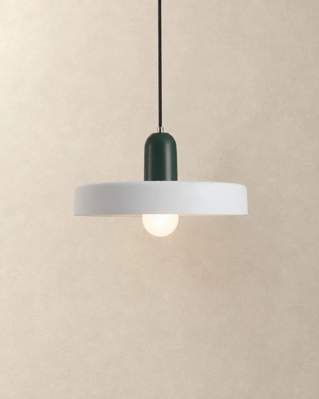 White pendant light with dark green holder