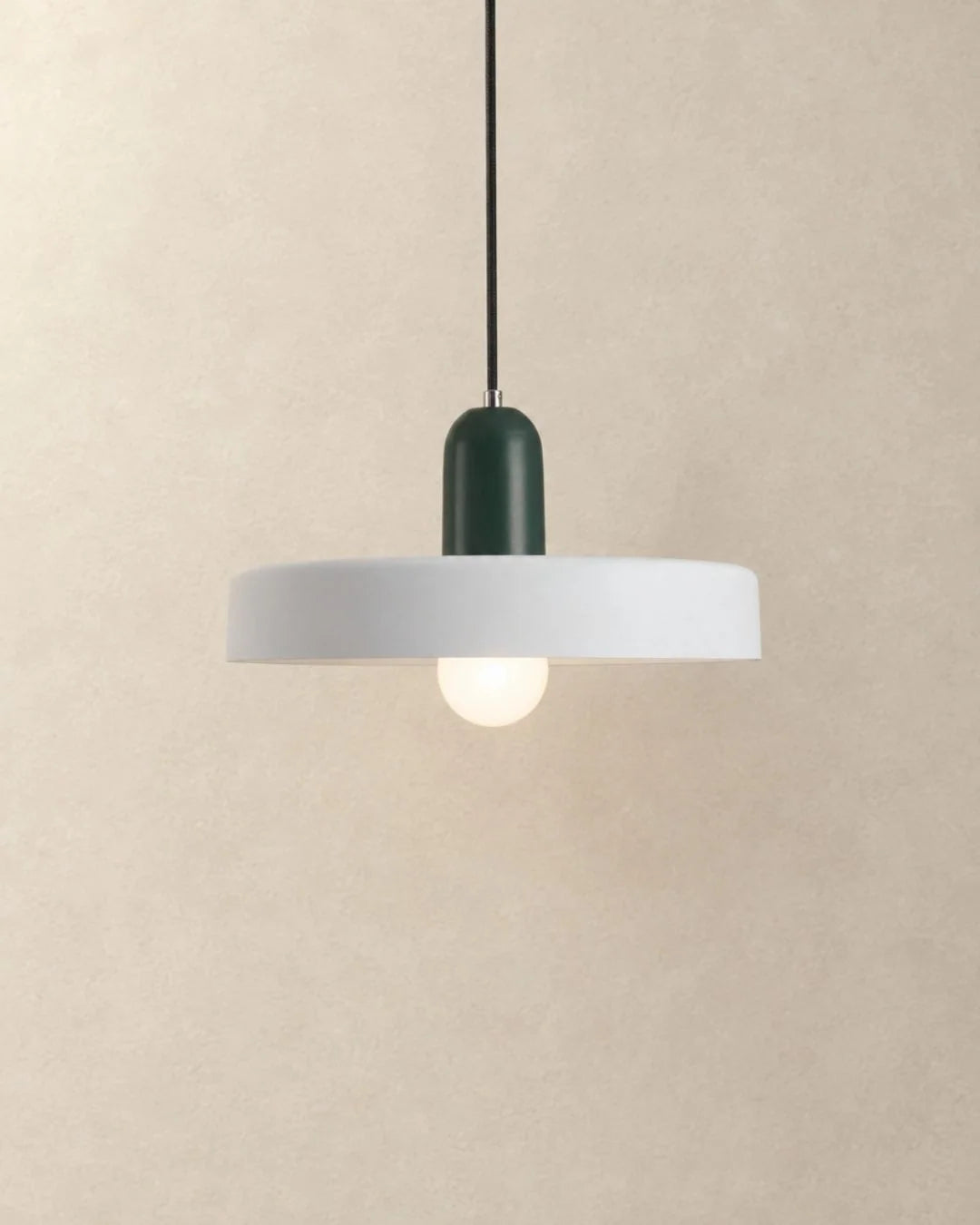 White pendant light with dark green holder