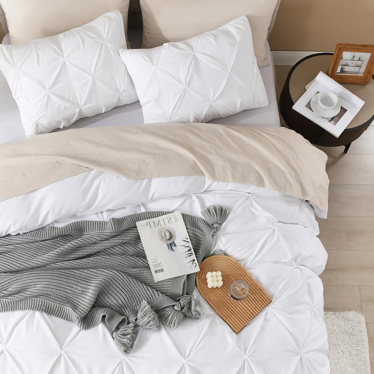 White pinch pleat bedding with gray throw