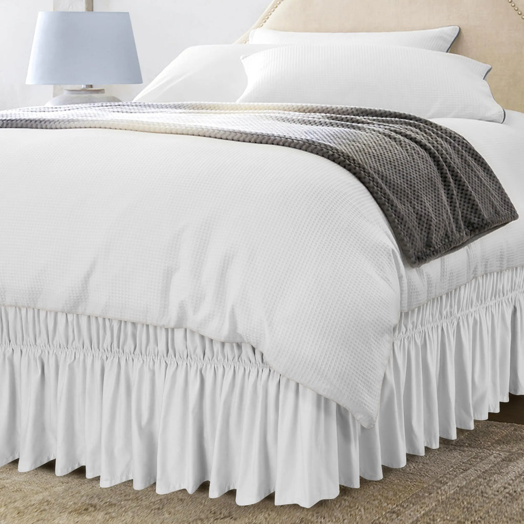White ruffle bed skirt with gray throw