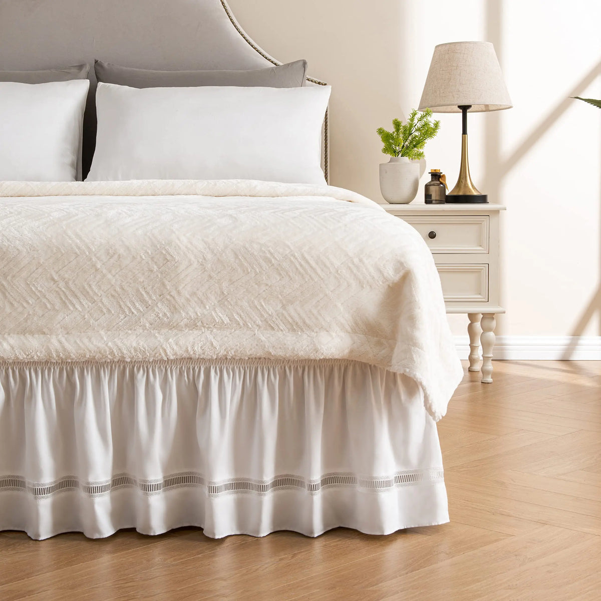 White ruffled bed skirt with crochet lace on bed