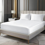 White satin fitted sheet set on bed