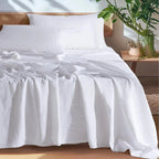 White washed linen sheet set on bed