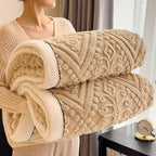 Woman holding rolled camel embossed sherpa blanket