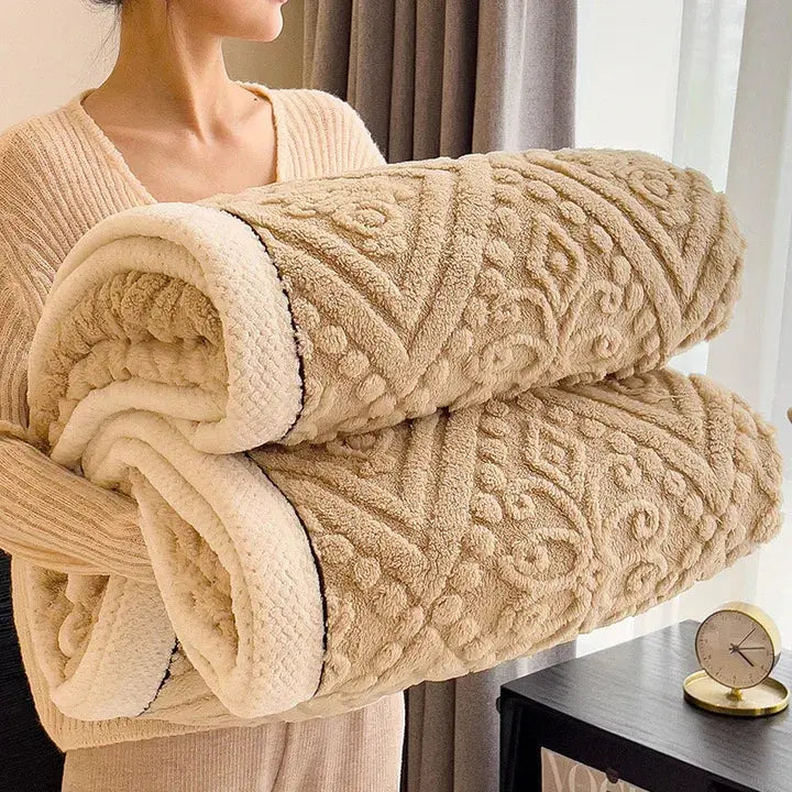 Woman holding rolled camel embossed sherpa blanket