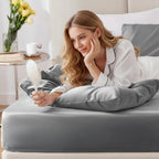 Woman relaxing on gray bamboo fitted sheet