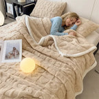Woman resting under heart embossed sherpa blanket