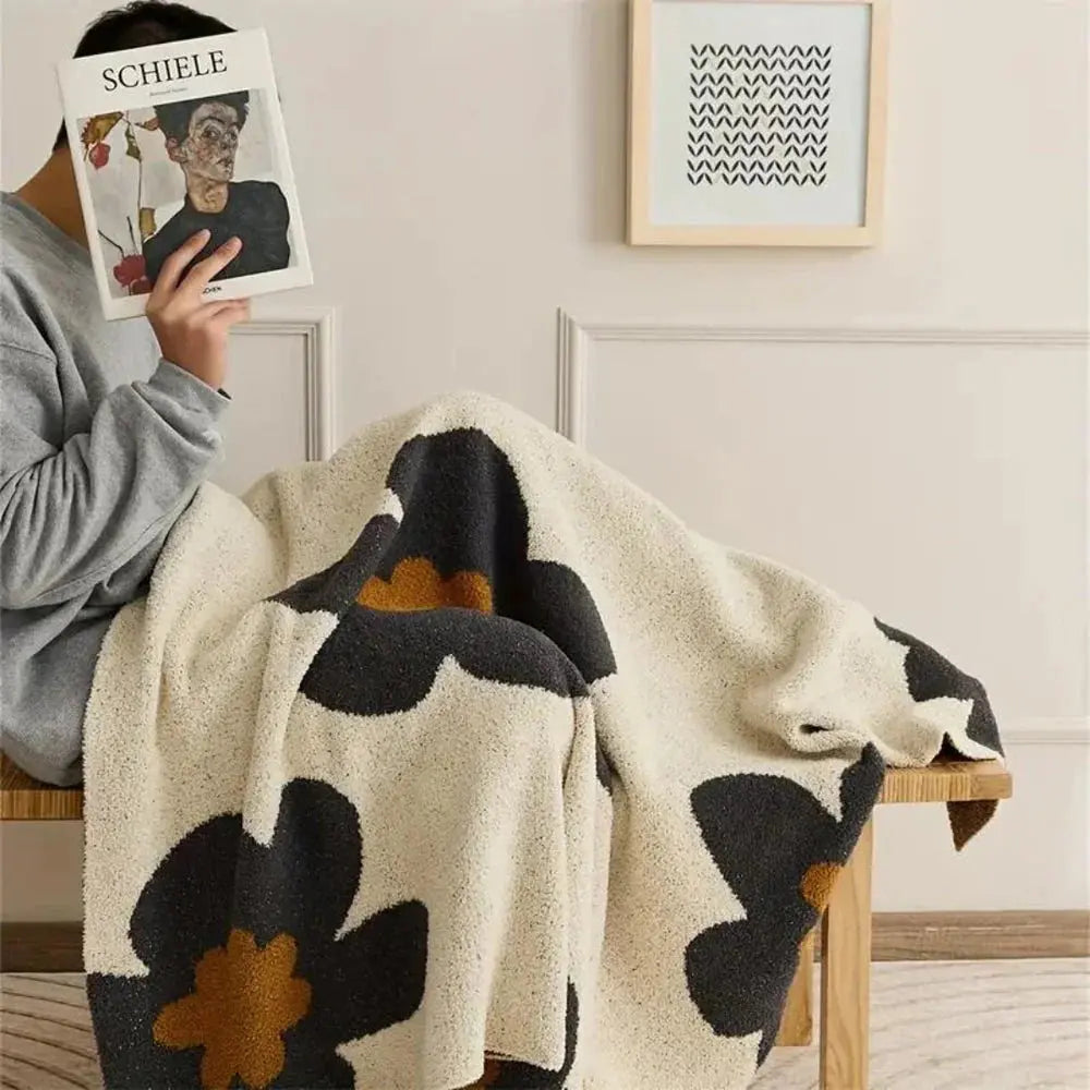 Woman with floral fleece throw on chair