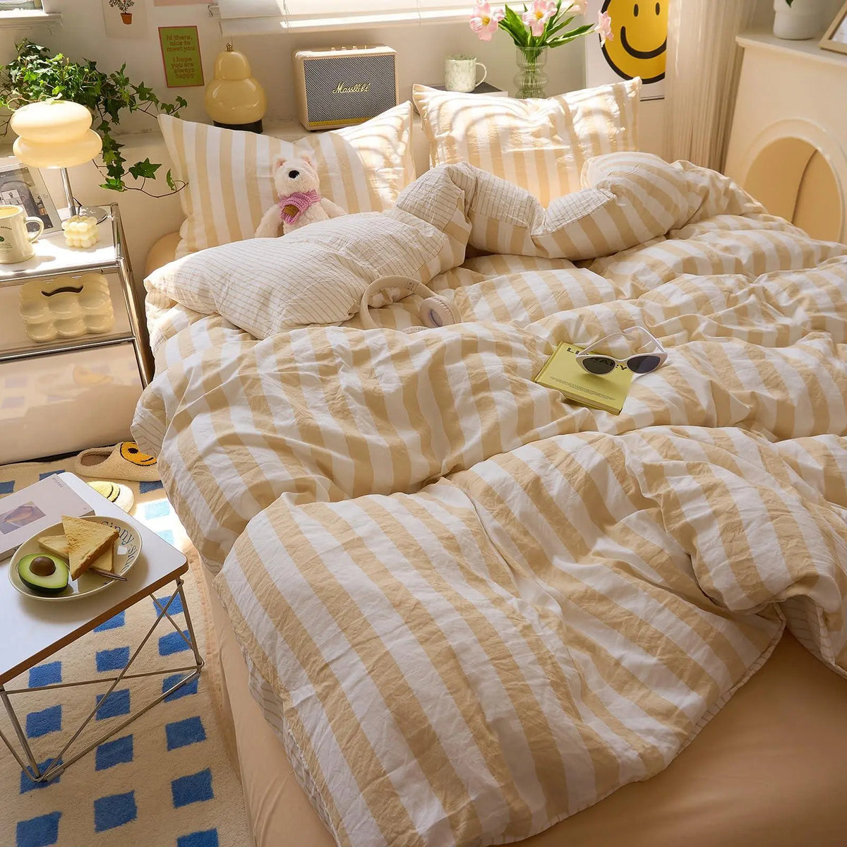 Yellow striped bedding with teddy bear