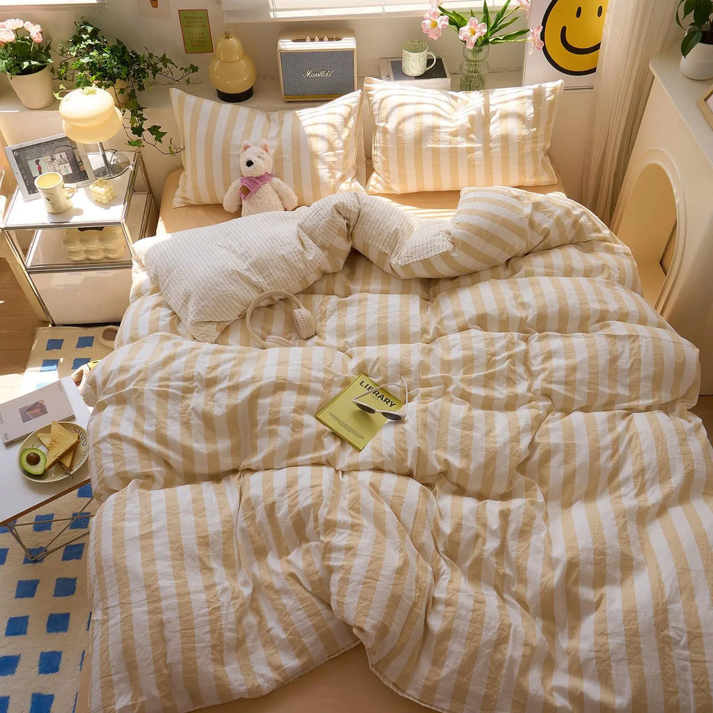 Yellow striped cotton bedding on bed