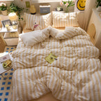 Yellow striped cotton bedding on bed